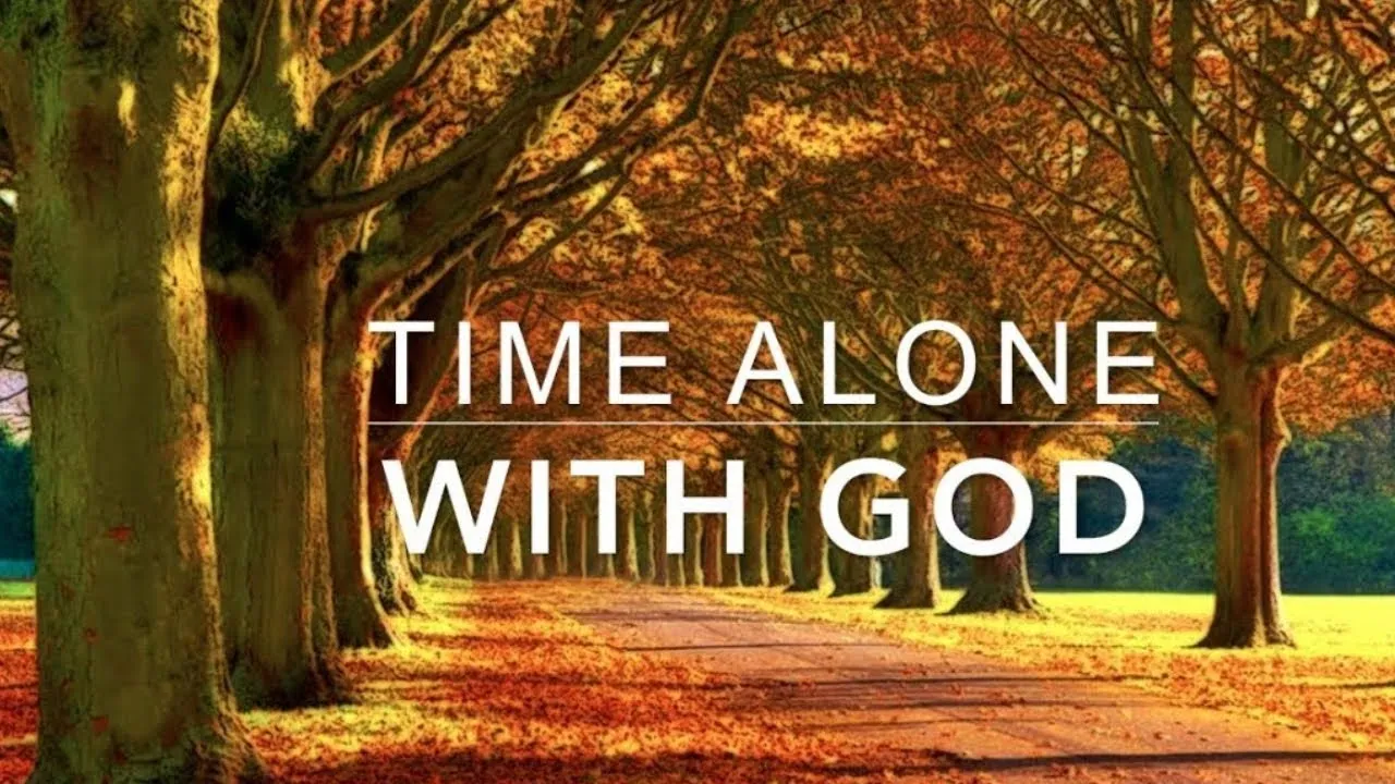 Path covered with autumn leaves and trees with text 'Time Alone With God' for worship piano music.